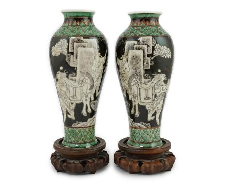 A pair of Chinese black ground enamelled porcelain baluster vases, late 19th century, each painted in an unusual black and wh