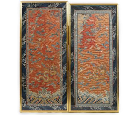 A pair of Chinese coral silk ‘dragon’ panels, 19th century, worked in polychrome silk and gold thread with dragons amid cloud
