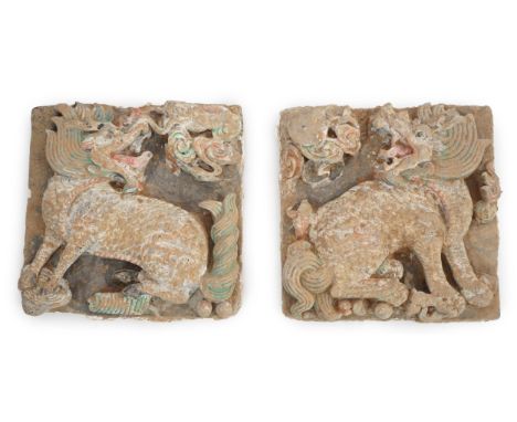 A fine pair of large Chinese painted pottery ‘Qilin, Sun and Moon’ tiles, Ming Dynasty (1368-1644) each cold painted in black