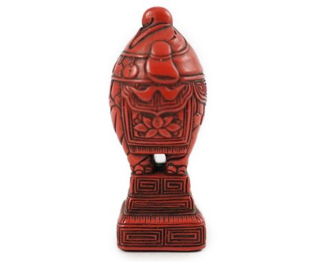 A small Japanese tsuishu (carved red lacquer) seal netsuke, 19th century, modelled as a stylised elephant, it’s face looking 