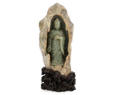 A large Chinese green jade 'Buddha Shakyamuni' boulder carving, in Tang style, but 20th century, the boulder with a grey/russ