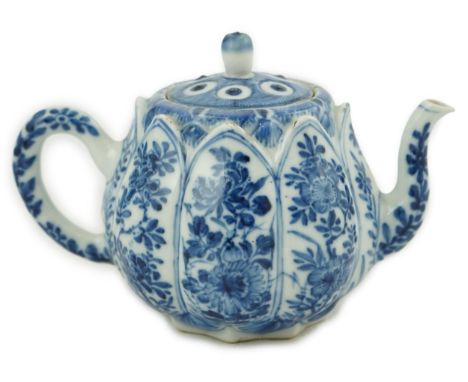 A Chinese blue and white lotus pod-shaped teapot and cover, Kangxi period, the eight side panels painted with flowering shrub