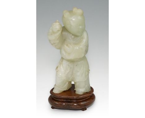 A Chinese pale celadon jade figure of a boy, 18th century, the standing boy with belted robe and hair in three tight curls, h