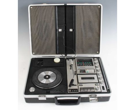 A Sanyo Solid State Stereo Music Centre, Model G 2311KL-2  with three speed turntable, tuner and cassette player in a briefca