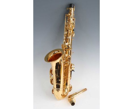 A The Fremont Excalibur alto saxophone, in brass with mother of peral buttons, serial no.65068, in fitted leather case.