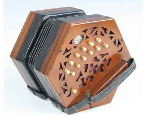 A late Victorian concertina, of typical hexagonal form, having mahogany fret carved ends with 25 bone buttons and five-fold l