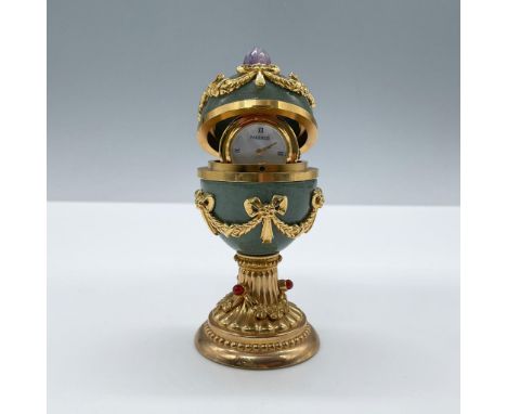 Jade enamel Faberge egg clock detailed in 24k gold and topped with an amethyst stone. Pearlized clock face marked Faberge. Al