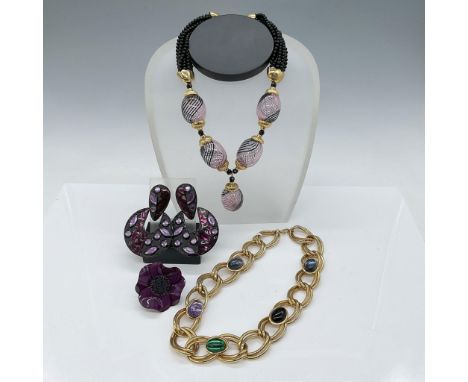 A vibrant collection of costume jewelry featuring two necklaces, a pair of earrings, and an adjustable floral ring. The stand