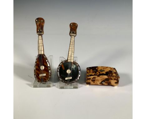 An endearing collection of miniature items, including musical instruments with small mother-of-pearl embellishments and a sma