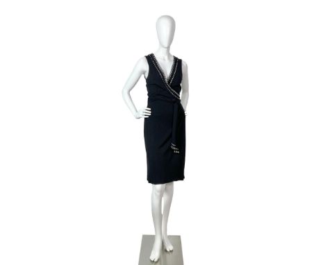 Vintage sheer black rayon sleeveless evening dress with rhinestones bands around the plunging V neckline. Closes with an atta