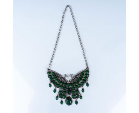 A striking silver butterfly pendant necklace featuring vibrant green cabochon stones. The pendant, crafted in an intricate de
