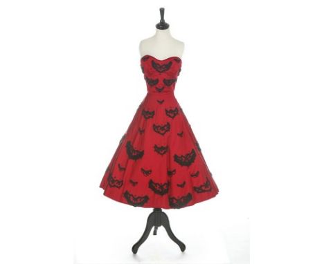 An American copy of a Dior cocktail dress, 1951, red silk grosgrain with  black passementerie with boned strapless bodice and