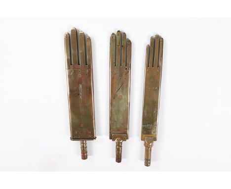 Three brass glove irons, circa 1900, two stamped 'James Ward, Worcester Ltd', the other 'WH. Hallett & Son, Halson Works Yeov