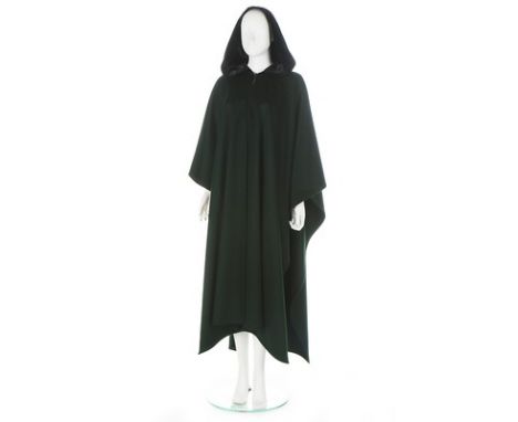 An Yves Saint Laurent dark green wool cape, 1970s, Rive Gauche labelled and size 38, with black velvet hood and singular butt