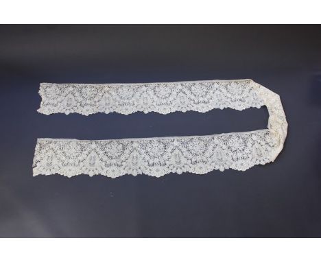 A good flounce of Brussels mixed lace, circa 1860, the dense bobbin lace ground inset with needlepoint cartouches, 23 by 345c
