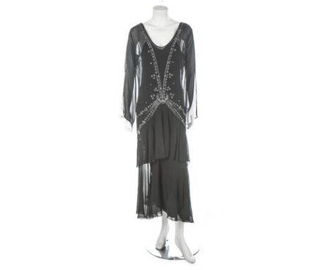 A black chiffon beaded dress, mid 1920s, un-labelled, with delicate floral motifs to the neckline, trailing down the centre f