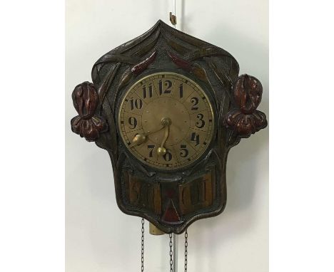 GERMAN ARTS &amp; CRAFTS WALL CLOCK,the brass circular dial within a wood surround carved and stained with stylised foliate d