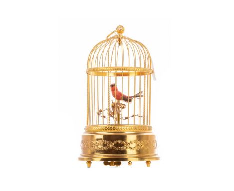 EARLY 20TH CENTURY MUSICAL AUTOMATON BY REUGE,with a bird modelled perching, with surrounding foliage, contained in a gilded 