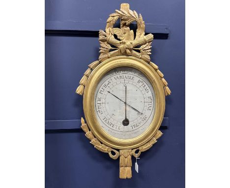 FRENCH LOUIS XVI GILTWOOD BAROMETER AND THERMOMETER,late 18th century, with carved surmount of doves perched amongst laurels,