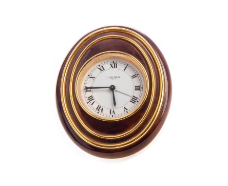 CARTIER TRAVELLING ALARM CLOCK,the white enamel dial stamped maker's mark, set with Roman numerals, within an oval gilt metal