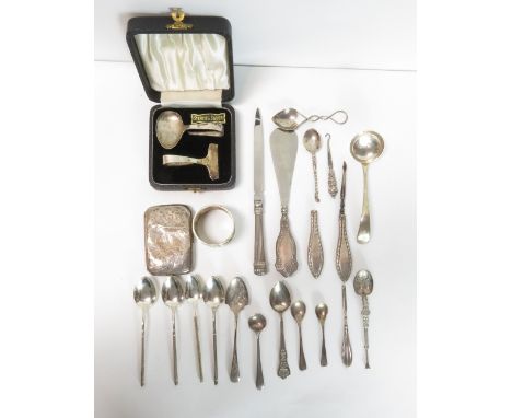 A cased silver spoon and pusher set; a silver cream ladle; six assorted silver spoons; and a silver cigarette case; 165g (5.3