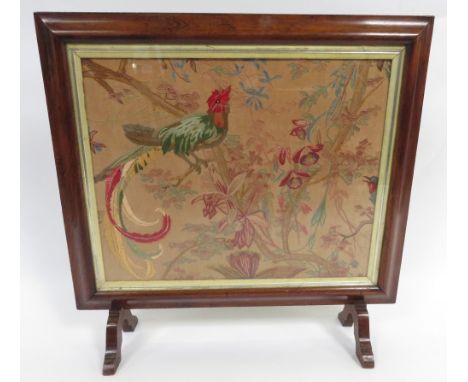 A 19th century fire screen, with tapestry of a bird perched on a branch, in a rosewood frame,83cm high, 86cm long