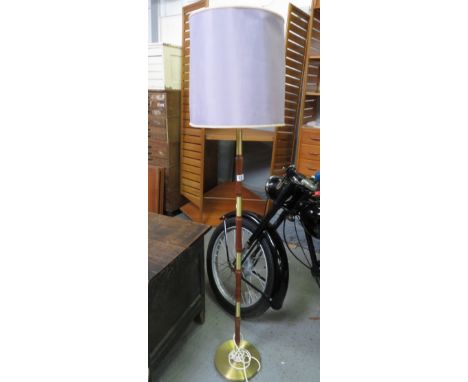 A mid century teak and brass standard lamp