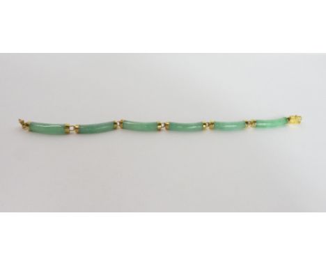 A jade bracelet, composed of six batons, the clasp with an oriental character stamped '14k' and '585', 17.5cm long