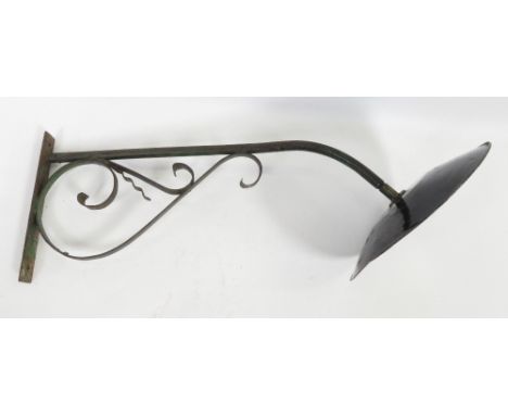 A 20th century iron wall light, with a black enamelled shade