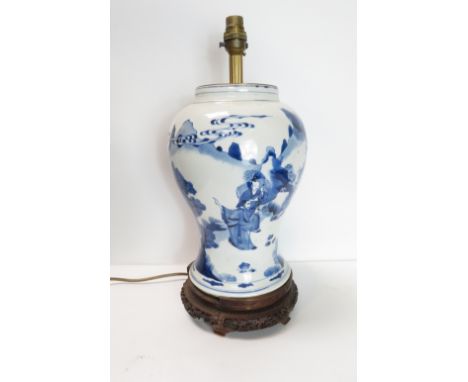 A Chinese blue and white vase of various figures riding a horse on wooden base, converted to a lamp 29cm high, (lamp only)