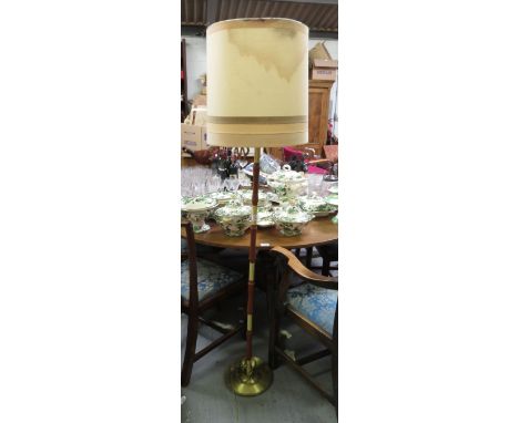 A mid century teak and brass standard lamp