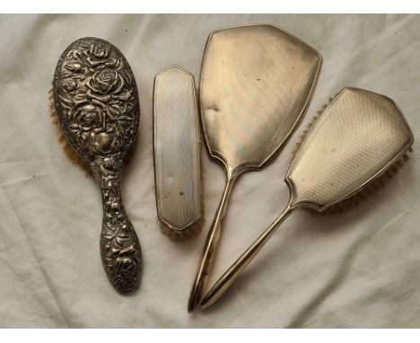 A three piece engine turned dressing table set and embossed back brush 