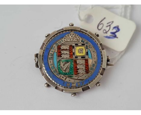 A silver and enamel coin brooch 