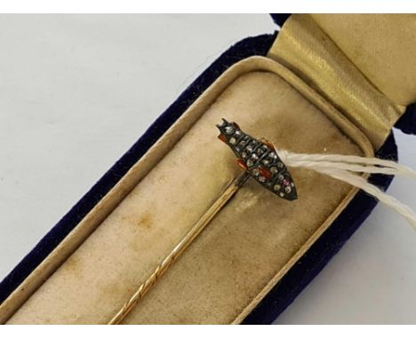 A cased stick pin with fish terminal of diamond and enamel with ruby eye 