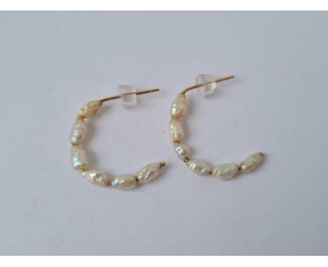 A pair of half hoop 9ct fresh water pearl earrings
