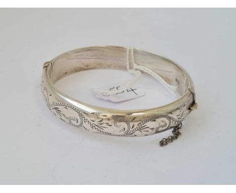 A silver scroll engraved hinged bangle 