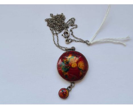 A arts and crafts silver and red enamel pendant on silver chain 