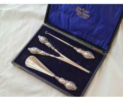 A boxed set of glove stretchers, button hook and a shoe horn with steel blades 