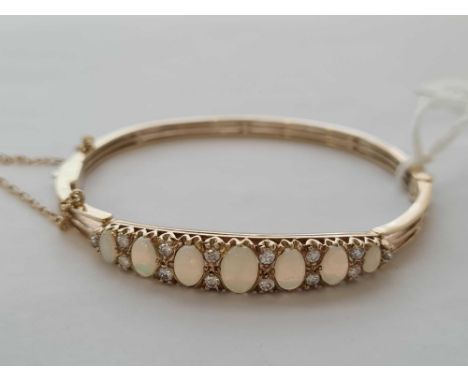 A ANTIQUE OPAL AND DIAMOND GOLD MOUNTED BANGLE 