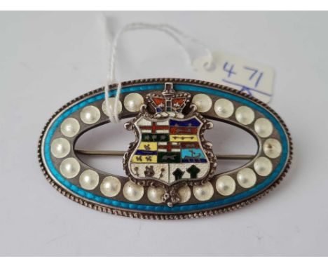 A large silver and enamel brooch