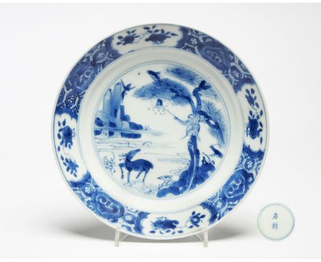 A rare Chinese blue and white 'Monkey, Deer, Bee and Magpie' dish, Kangxi, decorated with a deer by a river bank and a monkey