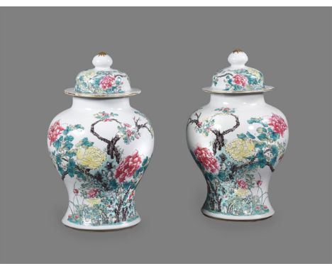 An attractive pair of Chinese Famille Rose vases and covers, Qing Dynasty, 19th century, well painted with peony shrubs in ye