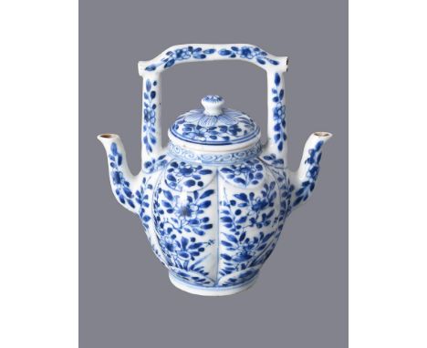 A good Chinese blue and white double-spouted teapot, Kangxi, the ovoid hexafoil body painted with flower-stems and foliage, r