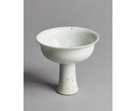 A Chinese shufu type white glazed stem cup, Yuan Dynasty (1279-1368), the cup with a slightly everted rim and standing on a h