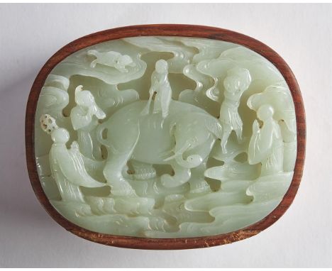A Chinese pale celadon jade mounted huanghuali box, Qing Dynasty, the jade top carved with an elephant whose head turns to on