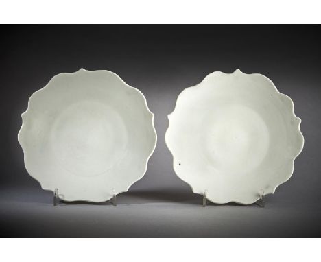 A fine pair of white-glazed five-petalled foliate dishes, Five Dynasties, circa 10th century, the flaring sides supported on 