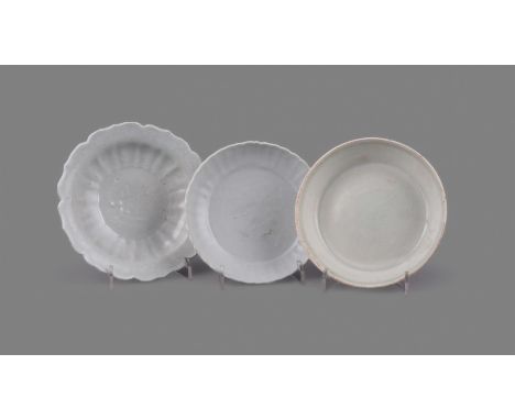 A Chinese qingbai small foliate rimmed dish, Yuan Dynasty (1271-1368), the centre moulded with a prunus branch, with moulded 