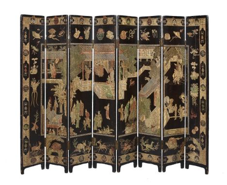 A Chinese lacquer eight-fold screen, Qing Dynasty, decorated on one side with dignitaries by buildings within a border of pre
