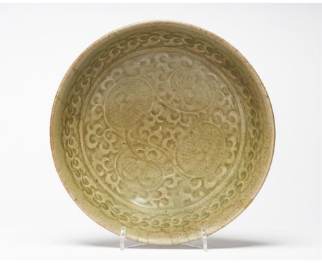 A Chinese Yaozhou celadon bowl, Northern Song Dynasty, 12th century, with moulded decoration to the interior with a composite