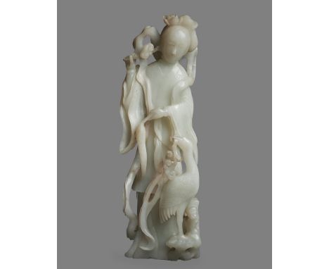 A large Chinese white jade figure of Guan Yin, Qing Dynasty, 19th century, the deity depicted with a smiling expression, wear